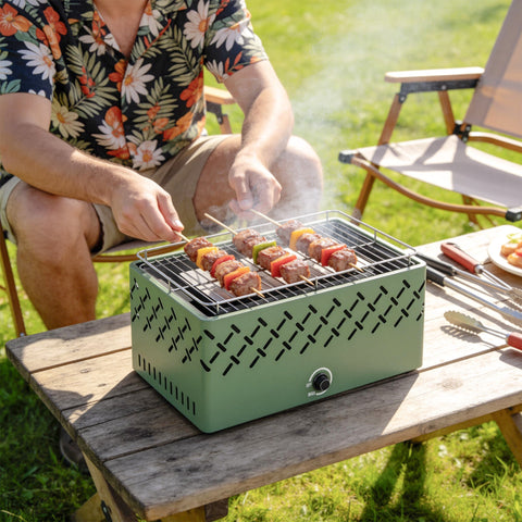 Outsunny portable light green charcoal grill with metal grate and charcoal tray for short camping trips and picnics