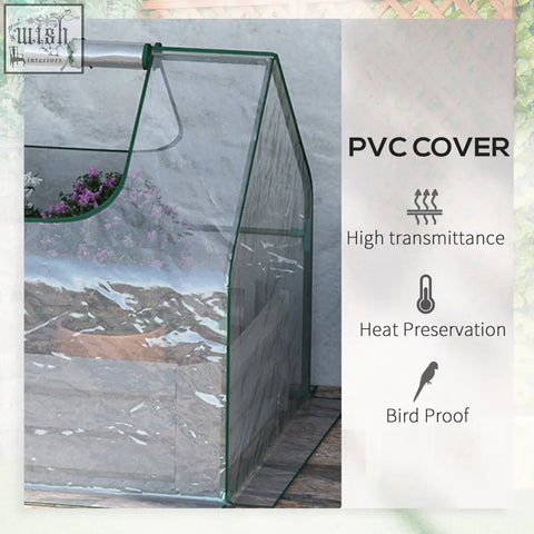 Outsunny raised garden bed with clear plastic cover and green metal frame greenhouse showing purple flowers inside