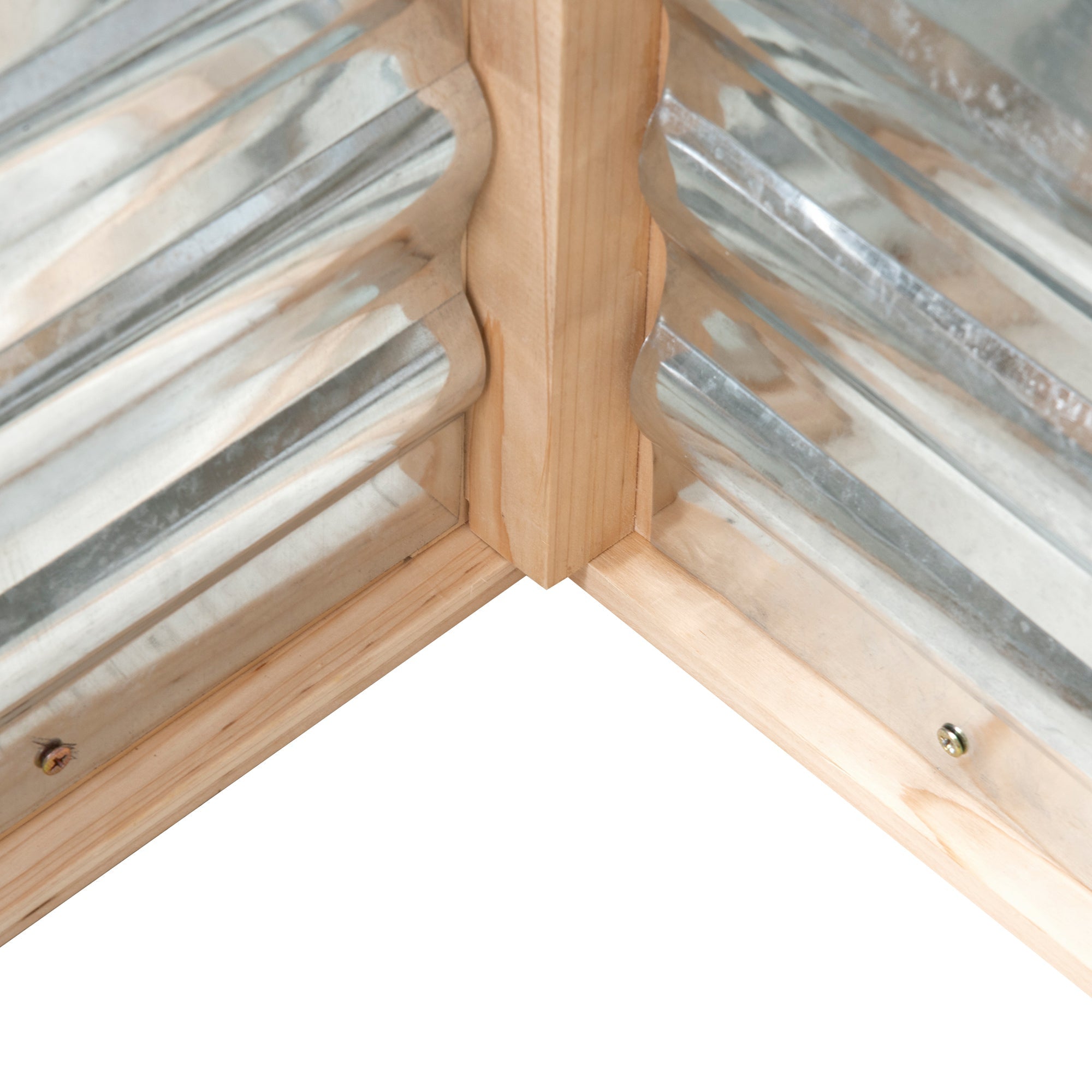 Light-colored wooden corner frame with corrugated metal panels in outsunny cold frame garden bed with greenhouse top