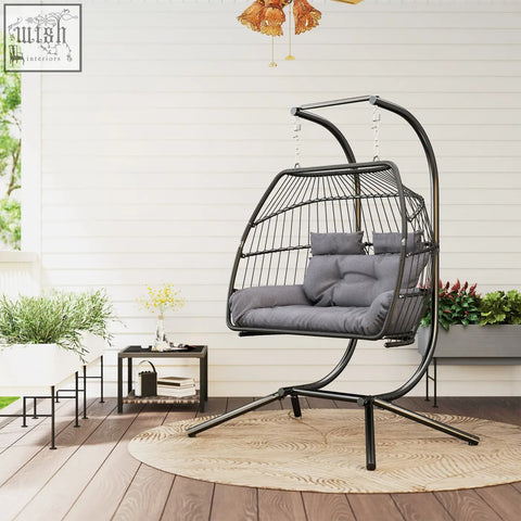 Black metal egg chair with gray cushioned seat and removable headrests in chic rope design for indoor outdoor use