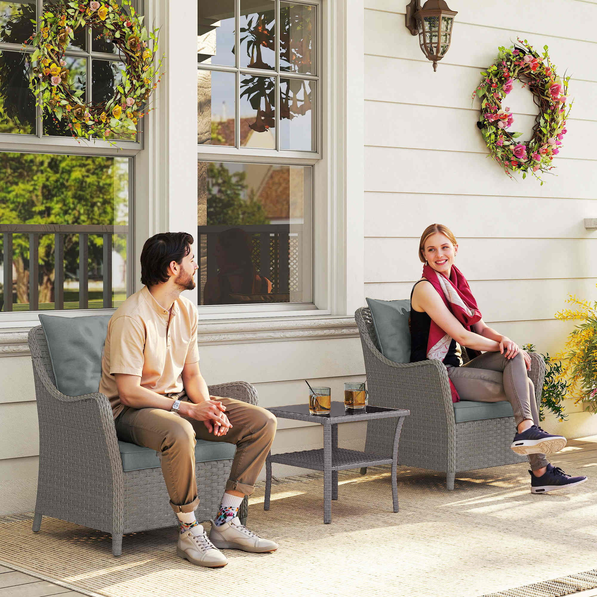 Gray woven rattan garden chair with gray seat cushion and steel frame perfect for outdoor patio or porch seating