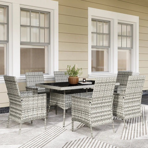 Gray woven wicker outdoor dining set with tempered glass table top and six chairs with cushions for terrace