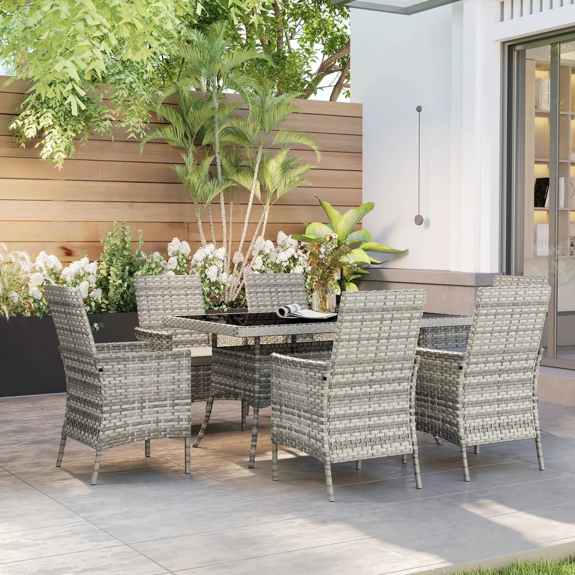 Gray woven wicker outdoor dining set with tempered glass table and six chairs perfect for garden or balcony use
