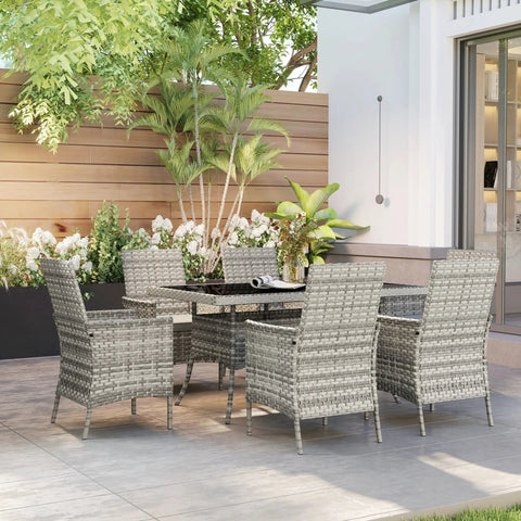 Gray woven wicker outdoor dining set with tempered glass table and six chairs perfect for garden or balcony use