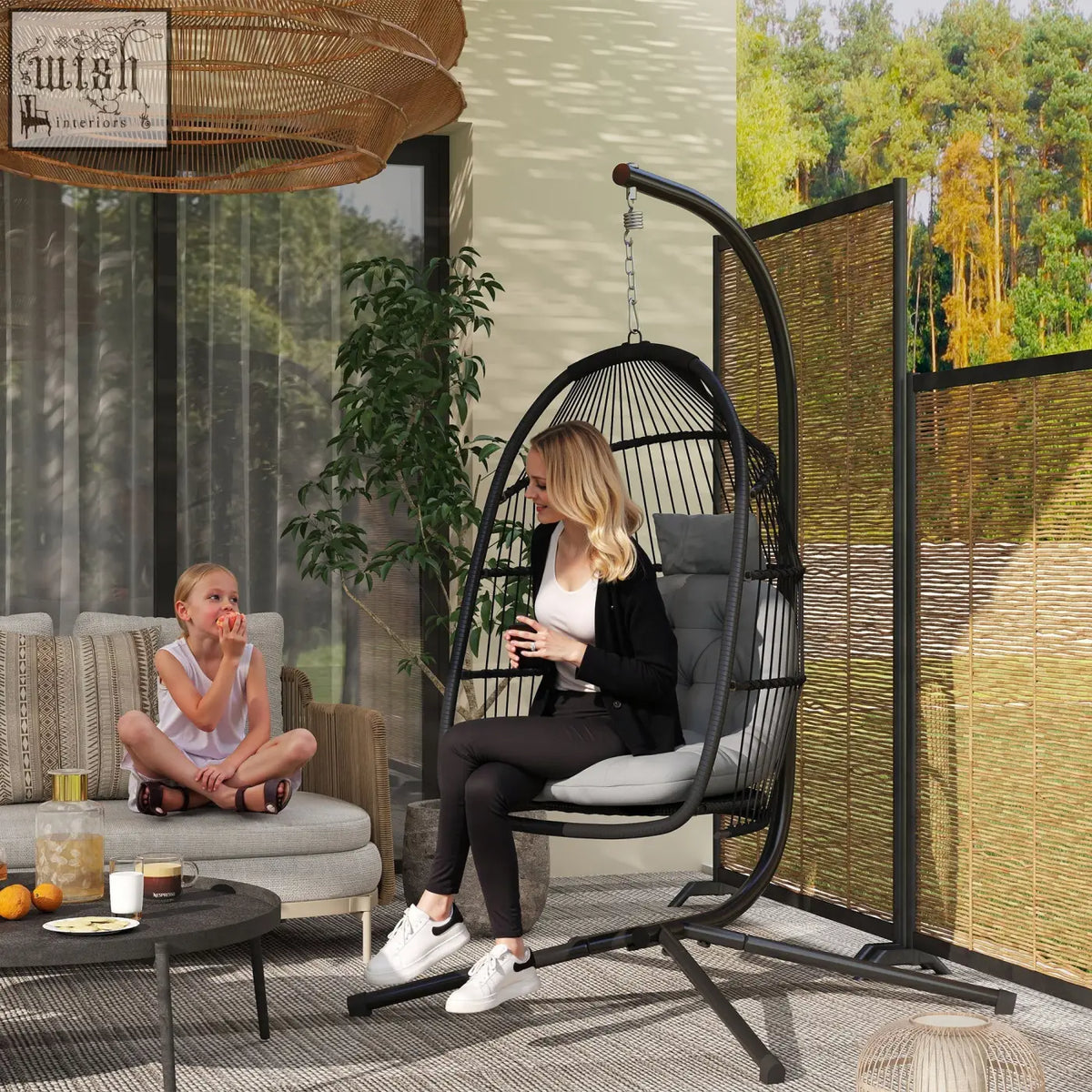 Black metal rattan swing chair with gray cushion and steel frame perfect for indoor outdoor use