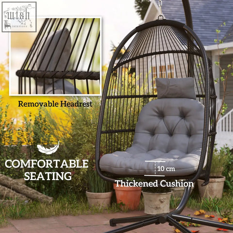 Black woven rattan swing chair with gray tufted cushion and steel frame perfect for indoor outdoor use