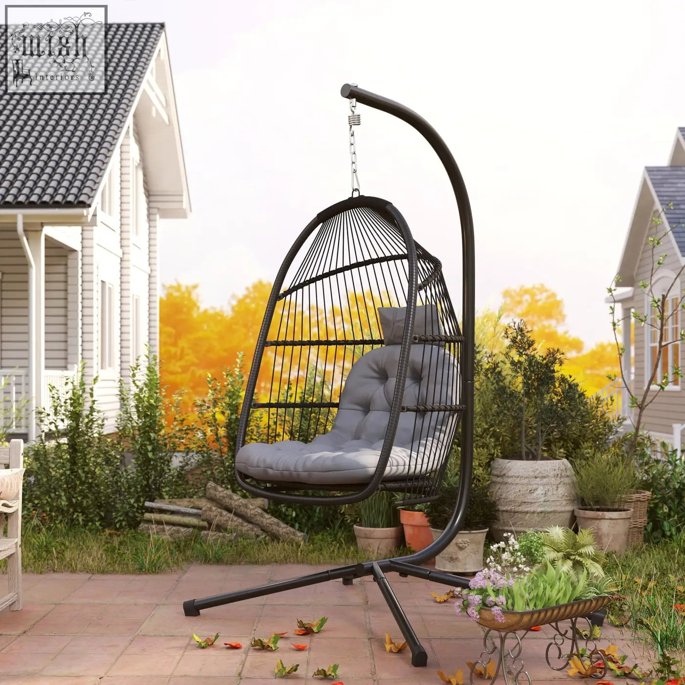Black wrought iron rattan swing chair with gray cushioned seat and steel frame perfect for indoor outdoor use