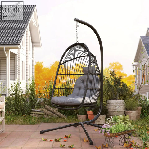 Black wrought iron rattan swing chair with gray cushioned seat and steel frame perfect for indoor outdoor use