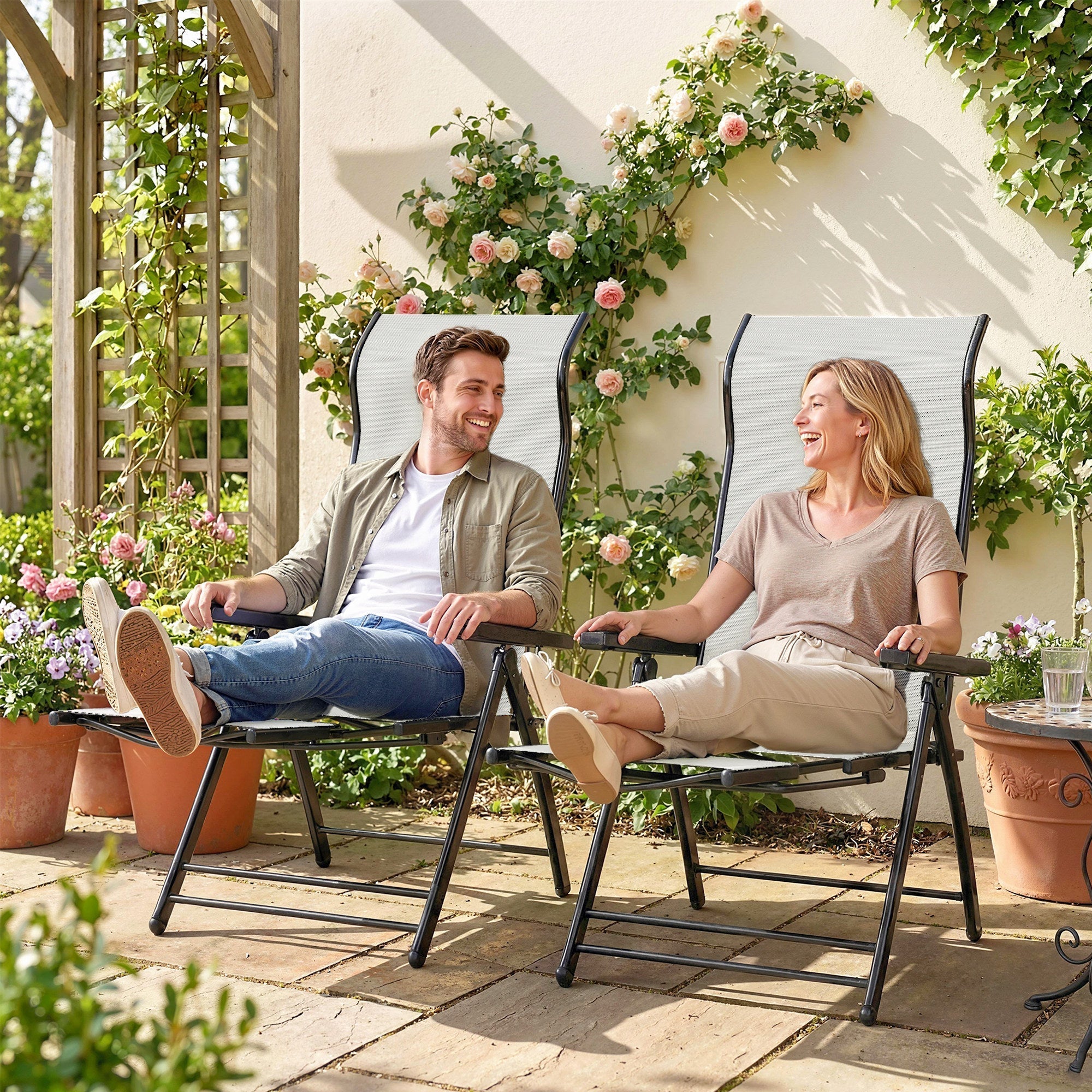Outsunny set of 2 black-framed folding garden recliners with light gray mesh fabric and retractable footrests