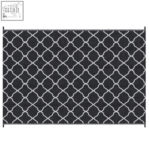 Black and white geometric patterned outsunny reversible outdoor rug with woven texture and carry bag for camping