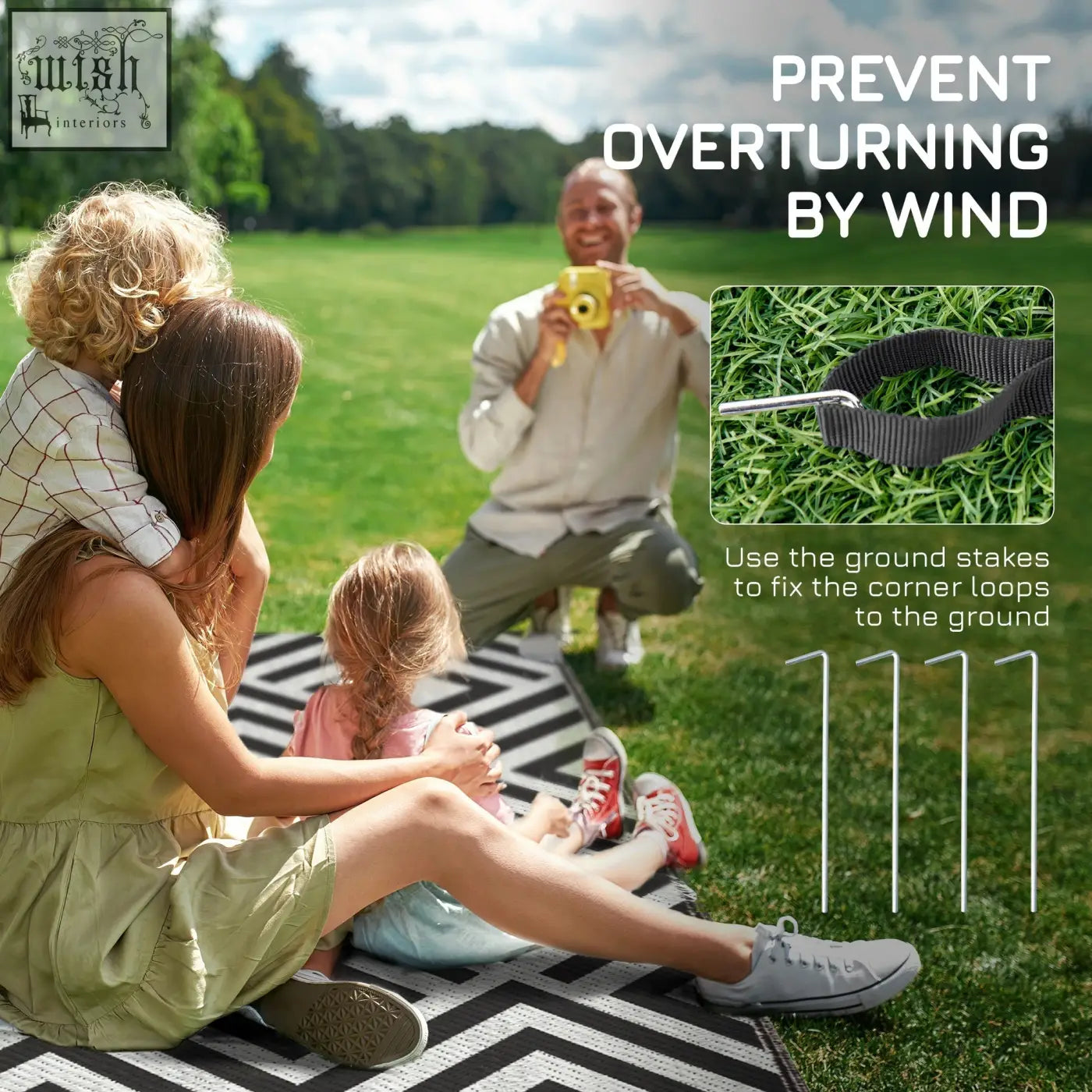 Black fabric strap with metal ground stakes for securing the Outsunny reversible outdoor rug with carry bag