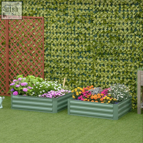 Two green galvanized metal raised garden beds filled with colorful flowers for flowers and herbs gardening