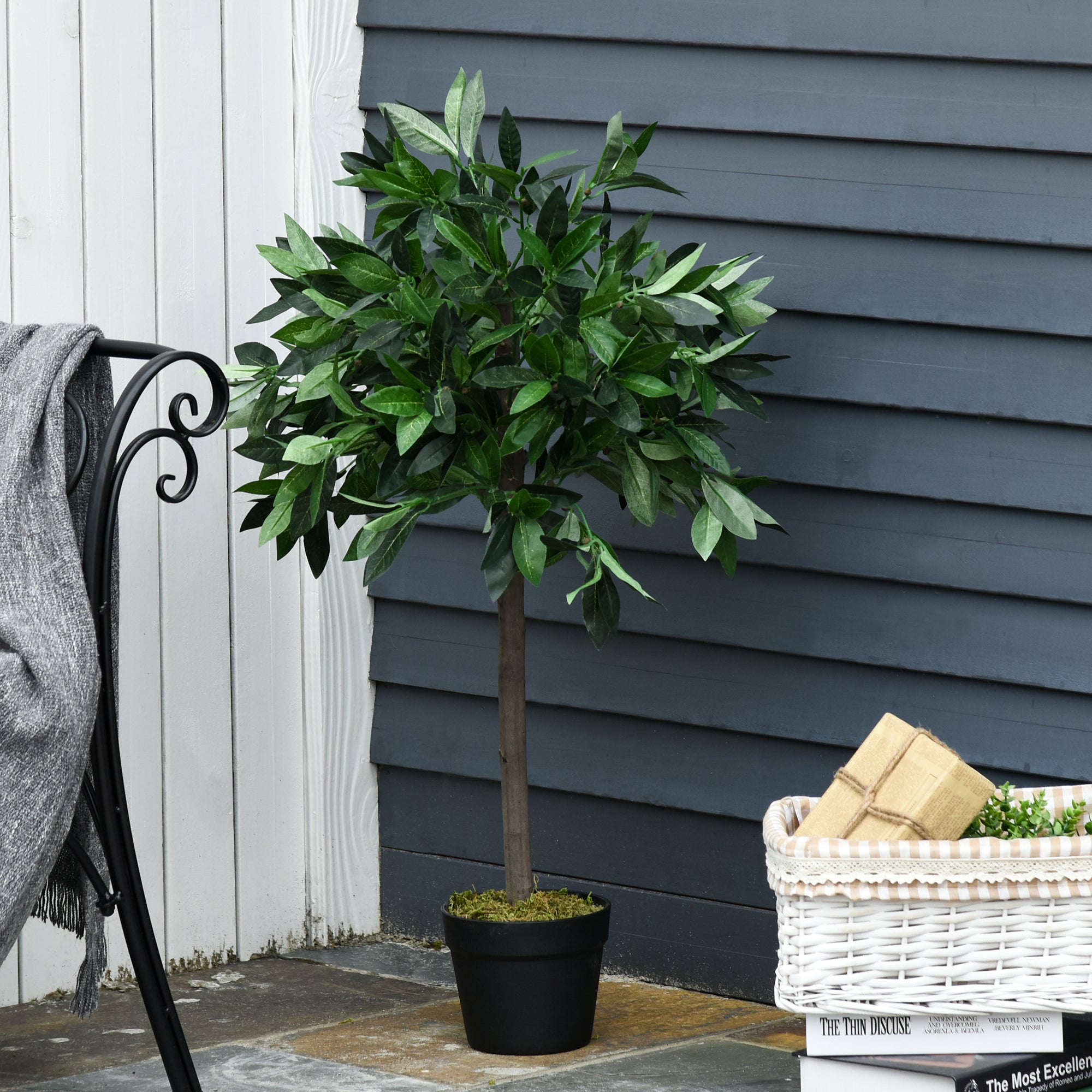 A set of 2 lush artificial bay tree topiary trees in sleek black pots perfect for year round indoor and outdoor decor