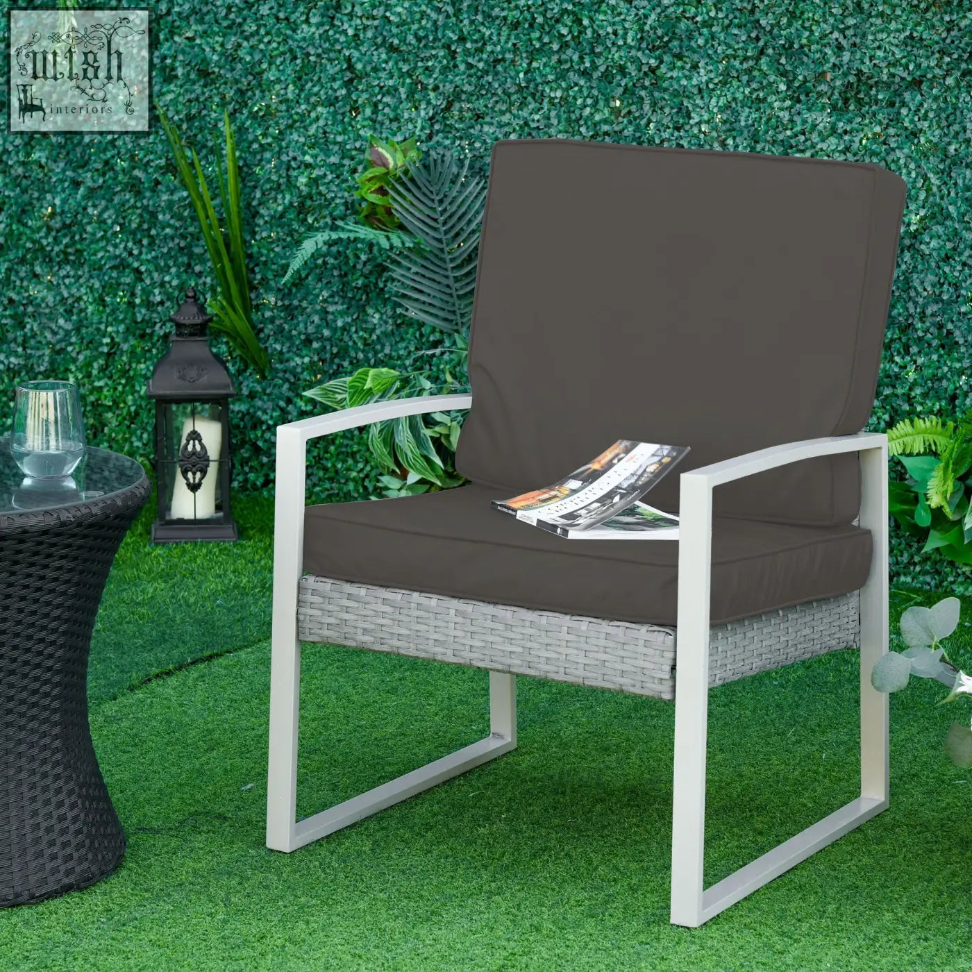 Gray woven wicker patio chair with white metal frame and dark gray seat cushion with polyester fabric covers
