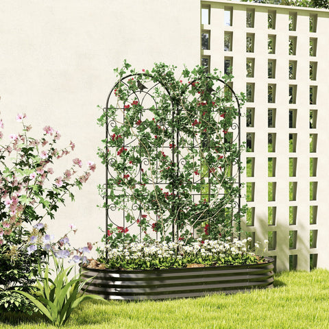Black wrought iron two trellises with ornate scrollwork offer lots of support for climbing plants and flowers in garden bed