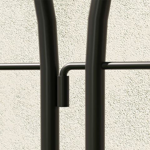 Black metal coat rack with sleek curved bars and minimalist design offering lots of space for hanging coats and bags