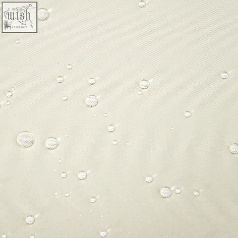 Clear water droplets on cream white polyester fabric of outsunny replacement cushions for rattan furniture