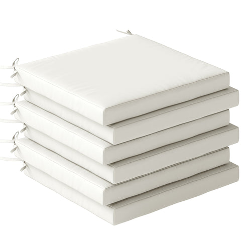 Stack of five cream white outdoor seat cushions with stitched edges and fabric ties for outdoor seating comfort