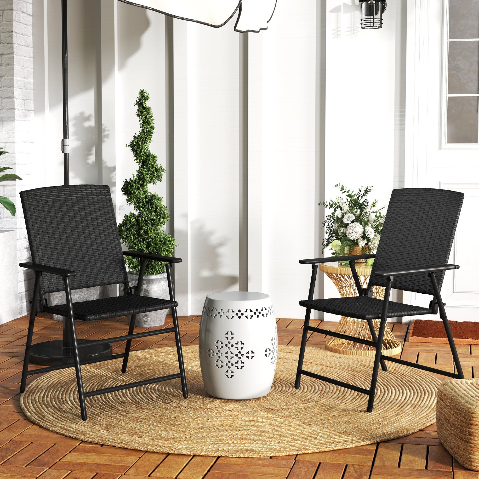 White ceramic garden stool with decorative black crosshatch pattern next to black foldable design rattan chair set