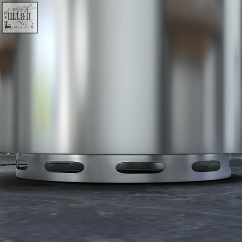 Silver stainless steel cylindrical fire pit with oval cutouts for high heat and secondary combustion outdoor use