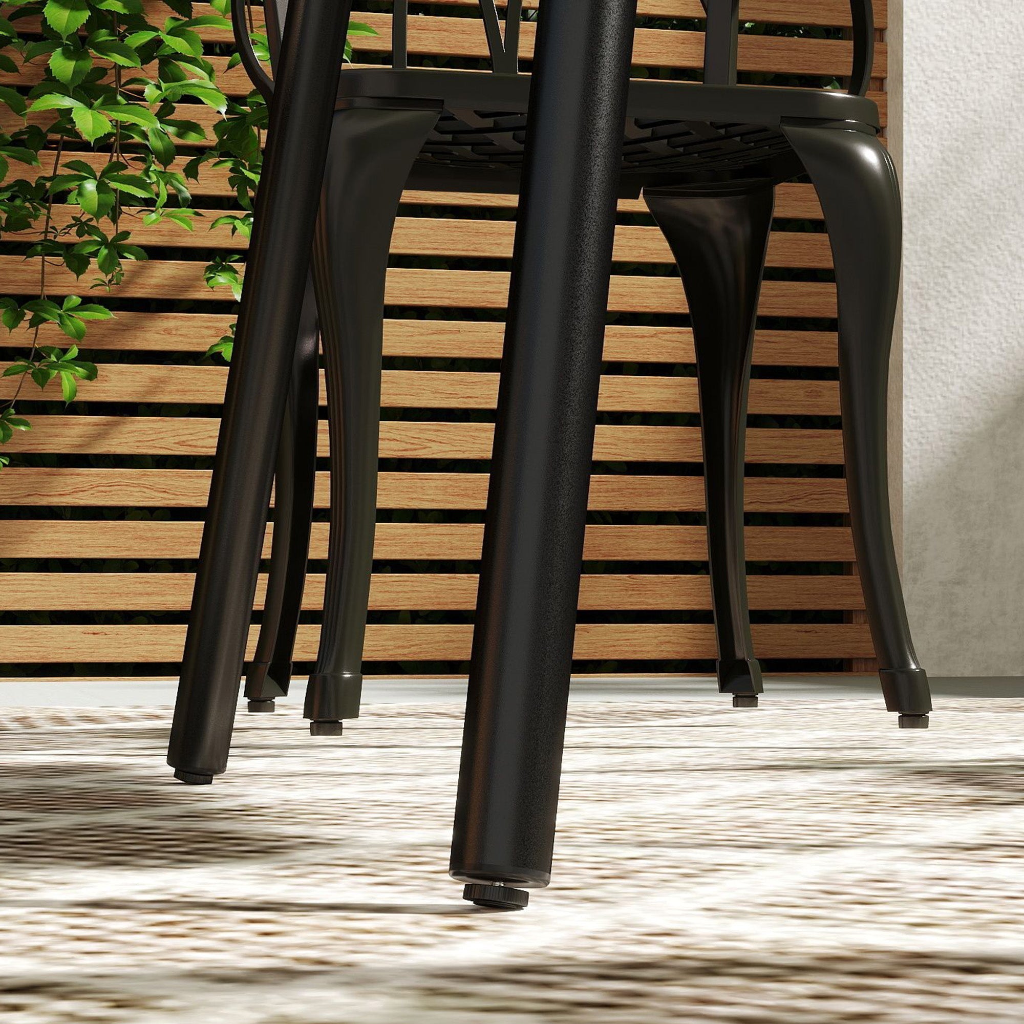 Black metal patio chair with curved legs and slatted backrest next to outsunny black garden table with powder-coated steel frame