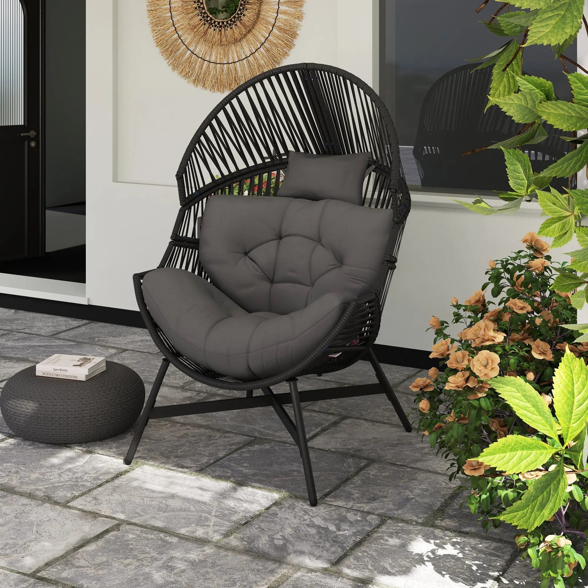 Black rattan egg chair with gray tufted cushion and charcoal powder-coated steel frame for outdoor use