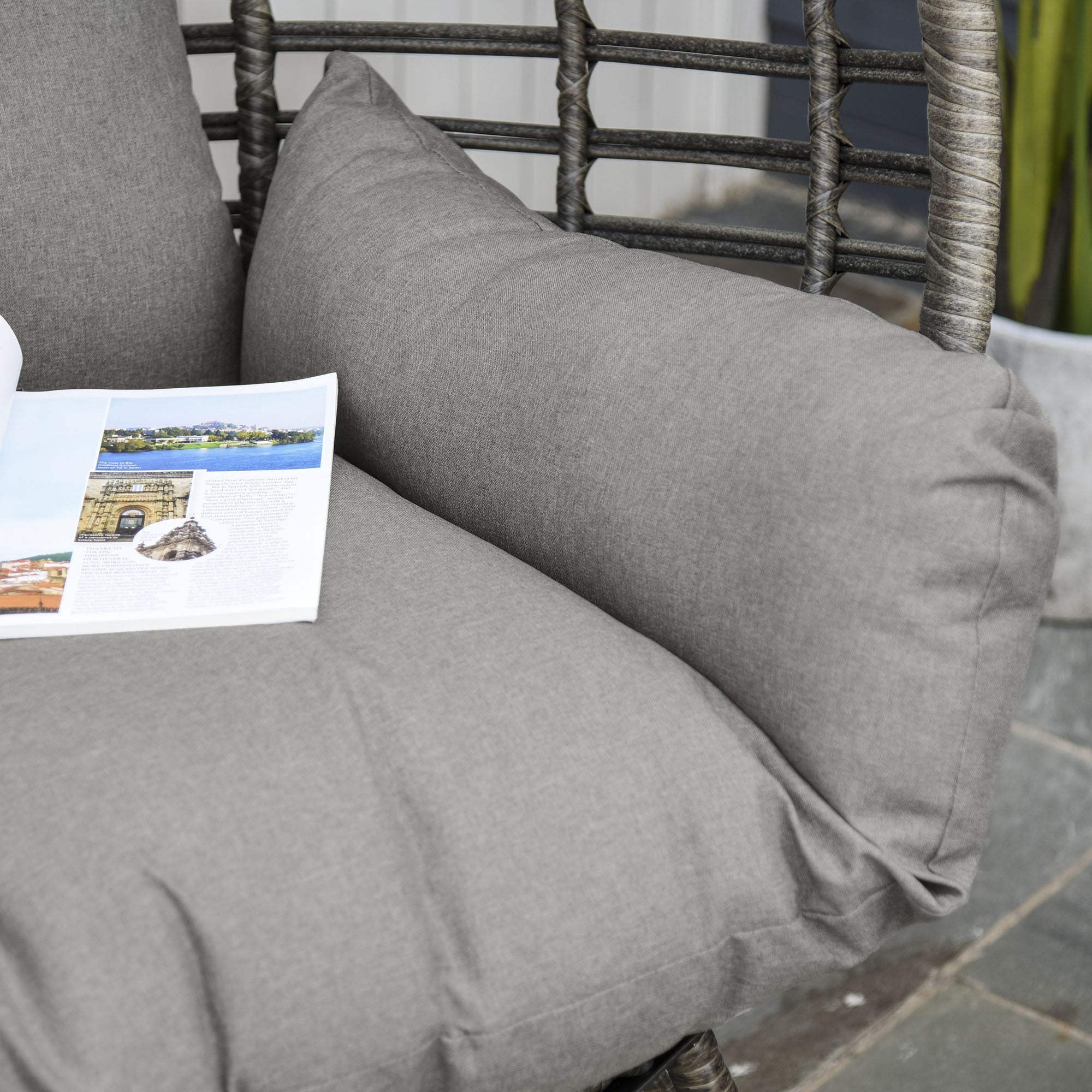 Gray textured outdoor cushion with heathered finish on woven rattan frame of Outsunny lazy chair seat