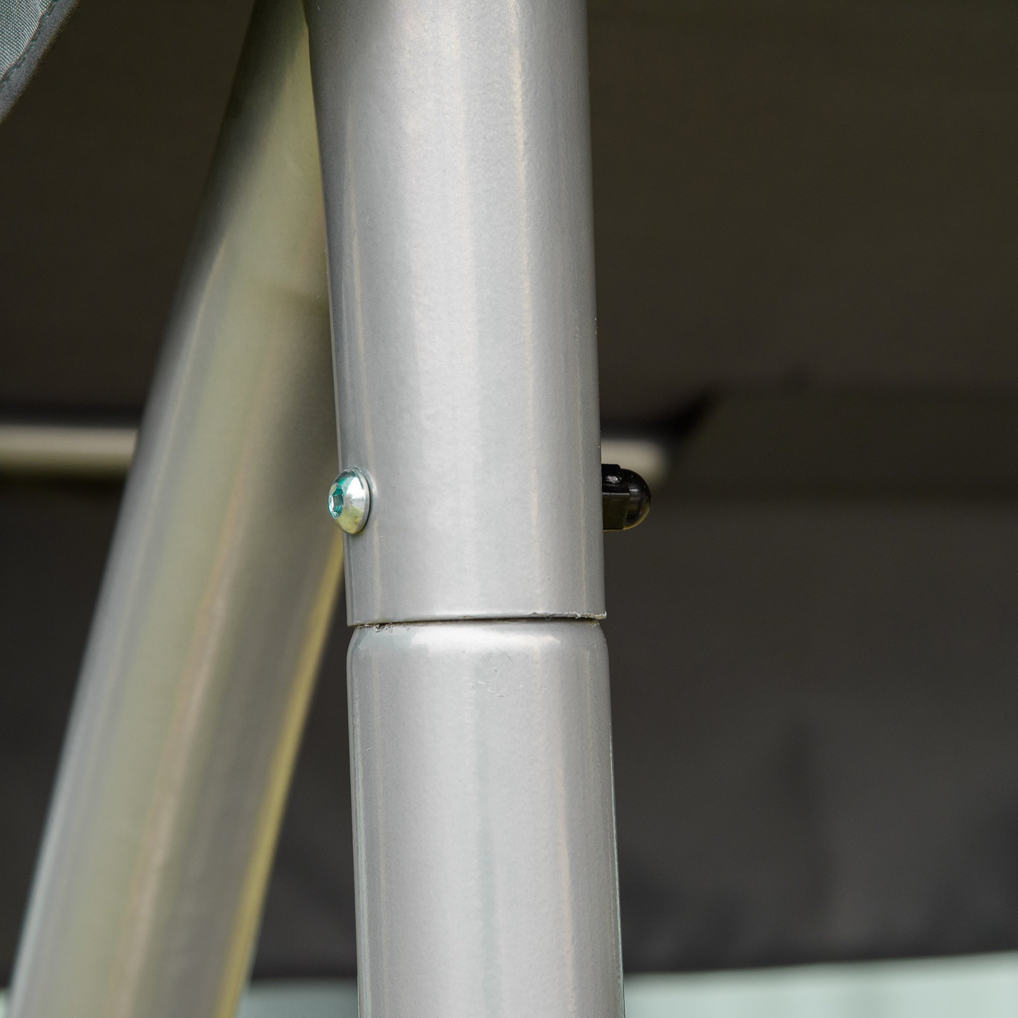 Silver metallic pole from the back of outsunny three person steel frame outdoor porch swing with adjustable canopy gray