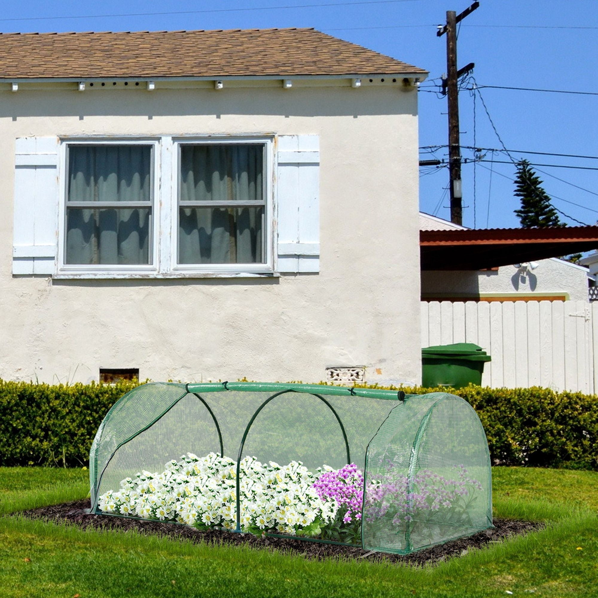 Green mesh garden cloche with steel frame and easy access covers white and purple flowers for outdoor use