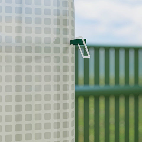 White and green plastic clip on a translucent pe cover of outsunny walk-in greenhouse with ground stakes included