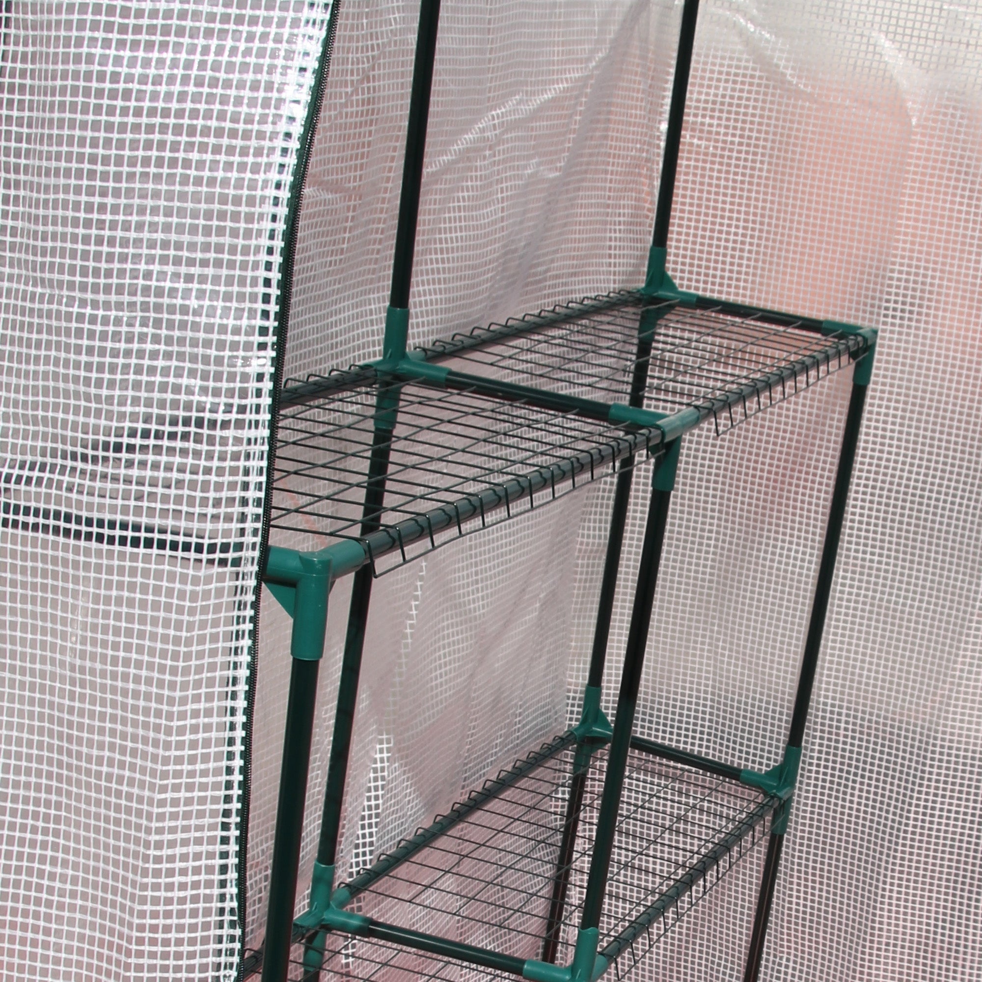 Green metal shelving unit with wire mesh shelves inside outsunny walk in greenhouse with roll-up door and reinforced pe cover
