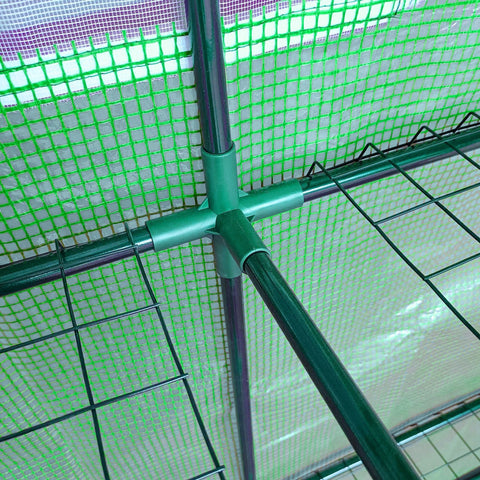 Green plastic corner joint connecting dark green metal poles in outsunny walk-in lean to wall greenhouse for plant nursery