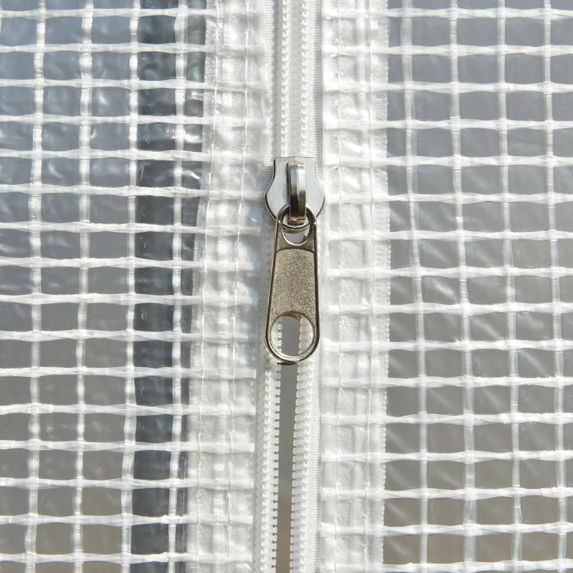 Silver-toned zipper with textured pull tab on easy access roll-up sidewall of white outsunny polytunnel greenhouse steel frame