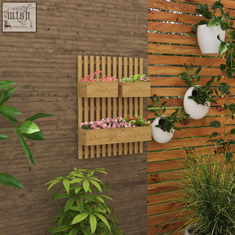 Light brown wooden wall-mounted planter box with three horizontal slots and drainage holes holding pink and green plants