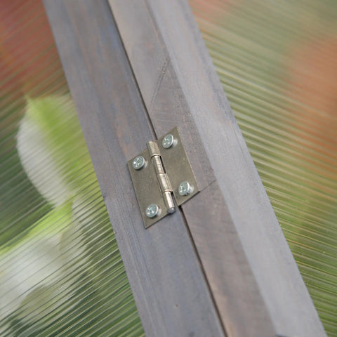 Metallic brushed silver hinge with four screws on dark gray wood panels of outsunny cold frame greenhouse grow house