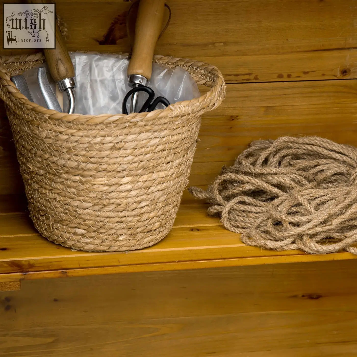 Woven natural fiber basket with sturdy wooden handles shown next to outsunny garden storage shed in natural wood effect fir wood