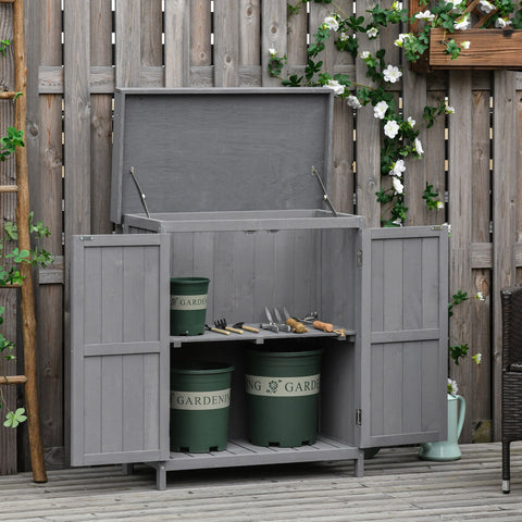 Gray wooden garden storage shed with hinged roof and double doors holding green buckets for outdoor storage