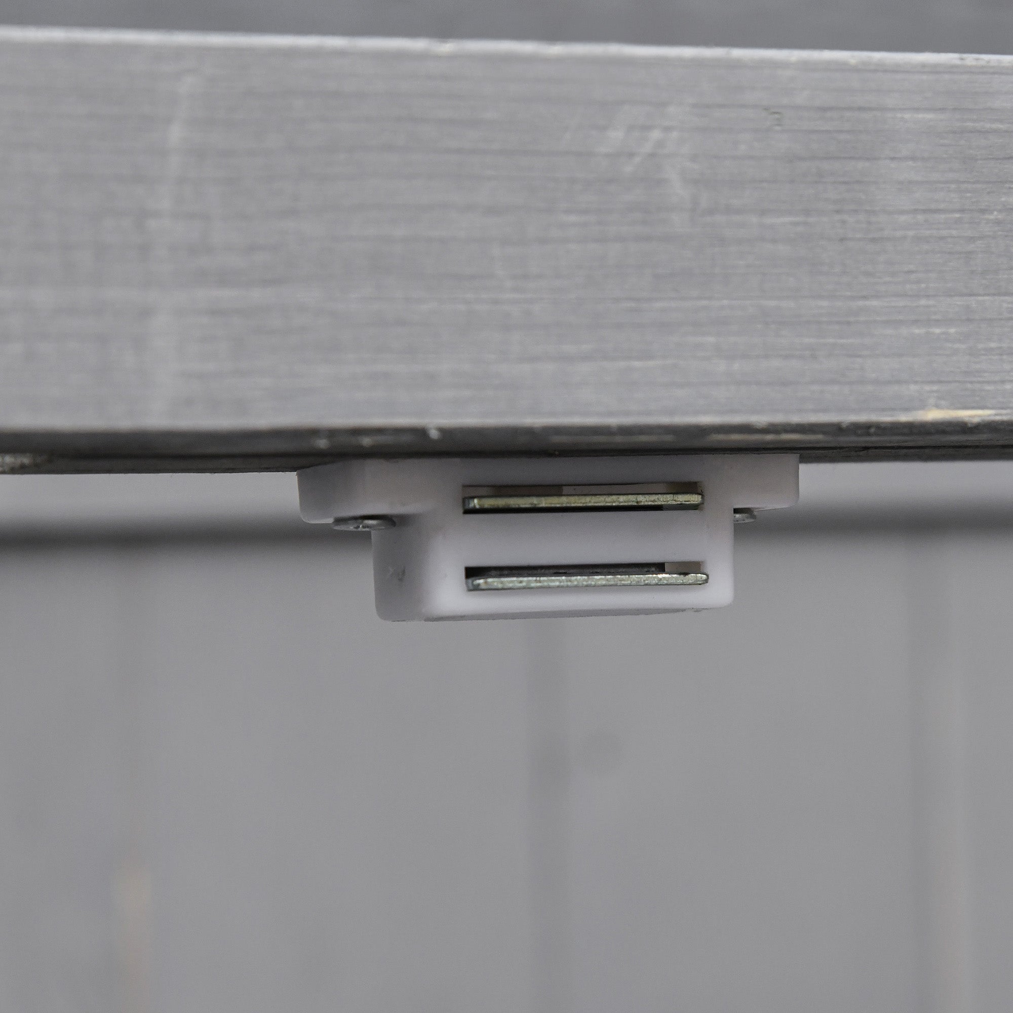 White plastic track mounted slide holder with two metal rails for grey outsunny garden storage shed with double doors