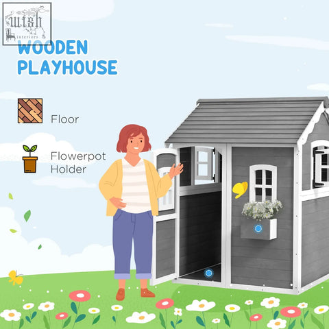 Gray wooden kids playhouse with white trim and plant box showing inside flooring for gardens and patios
