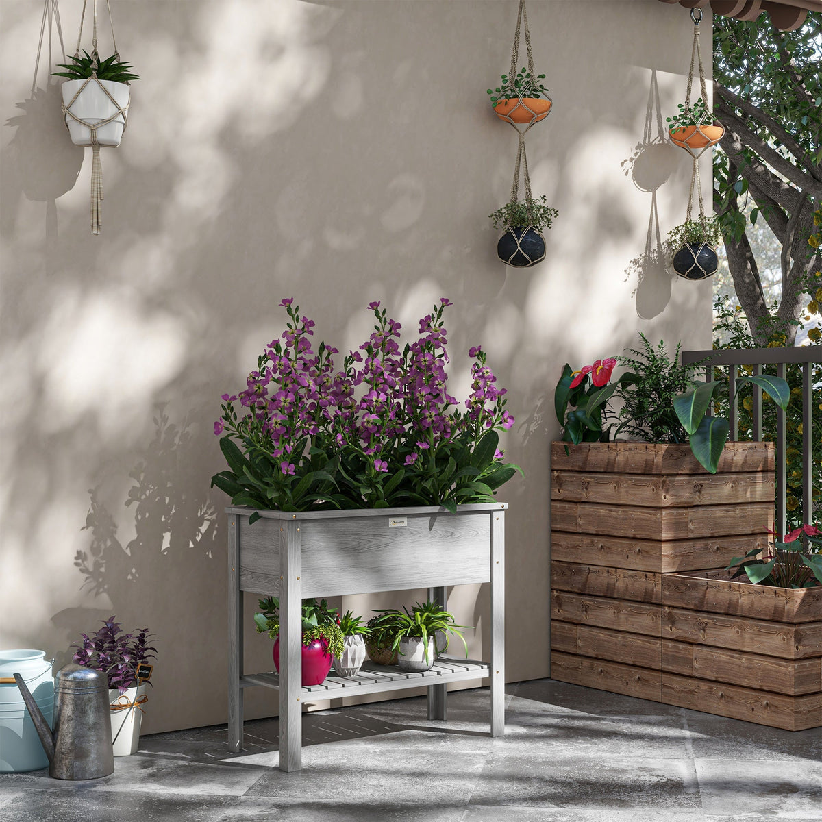 Gray wooden elevated planter box with lower storage shelf and drainage holes perfect as a raised garden bed