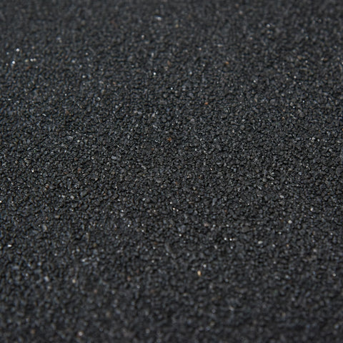 Black rubberized gravel with a coarse texture used for garden tool storage outside the outsunny wooden small shed 75l x 56w