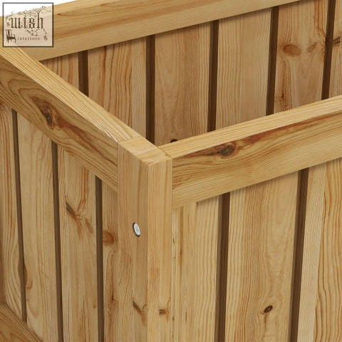 Light-colored wooden raised garden bed with vertical slats and natural wood grain for growing veggies and herbs