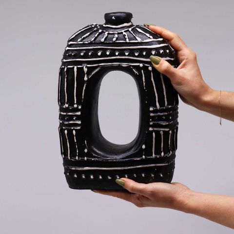 Black ceramic oval donut shaped dry flowers vase with white geometric patterns and a central oval cutout chocolate 30cm