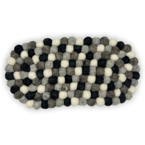 Oval felt ball centre mat in black gray and cream with woven checkerboard pattern made from soft felt balls