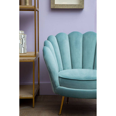 A teal velvet ovala blue scalloped chair with gold-tone legs perfect for stylish living spaces