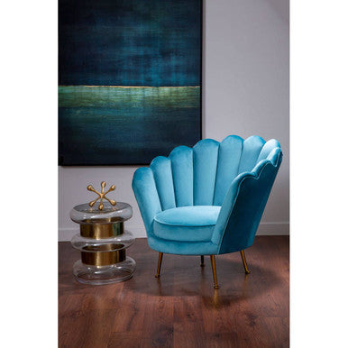 A vibrant turquoise velvet ovala blue scalloped chair with gold-tone legs perfect for stylish seating