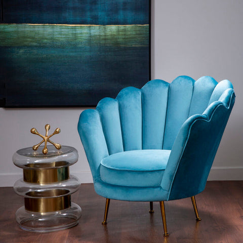 A vibrant turquoise velvet ovala blue scalloped chair with scalloped shell design and gold tone legs