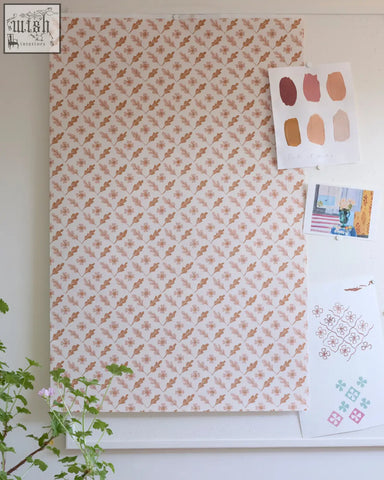 A rectangular oxalis oak wallpaper sheet with rippled leaves in pink and rust on an off-white background