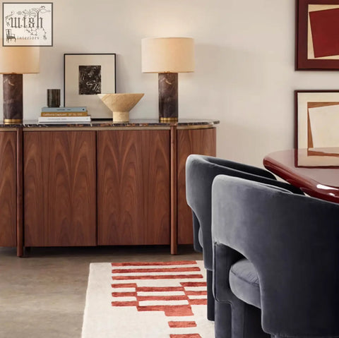 Dark wood sideboard with marble top and gold accents paired with velvet paddy dining chair for marble dining style