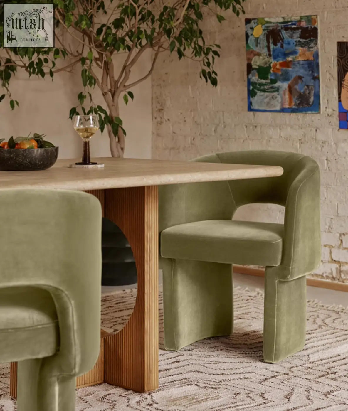 Olive green velvet paddy dining chair with curved modern design and wooden base perfect for marble dining table setups
